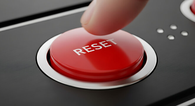 Extreme close-up of a tactile red reset push button being pressed on a dark matte control panel, symbolizing system restart, data recovery, industrial emergency stop, or starting over.