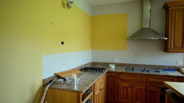 Wide View of outdated kitchen interior during demolition process before installation of new cabinets and appliances.