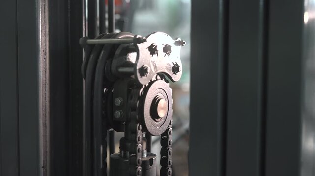 Mast Sprocket With Bearing And Lubricant. Close View Of Chain Mechanism On Industrial Mast . Media