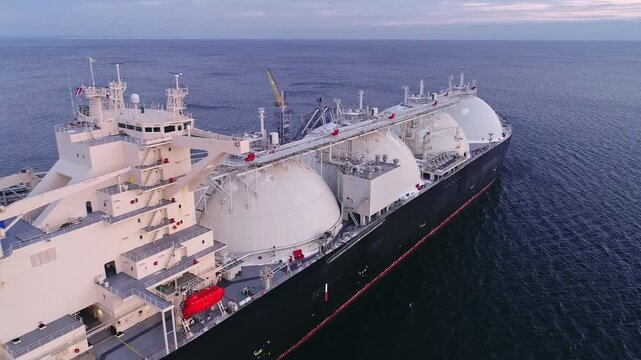 Aerial of Liquified Natural Gas LNG carrier moored to a small gas terminal. Fuel crisis. Sanctions