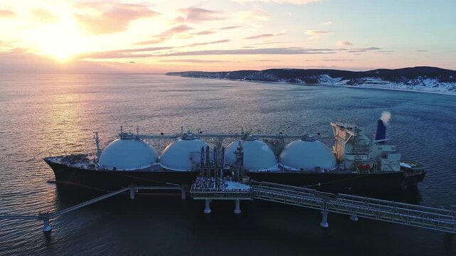 Aerial of Liquified Natural Gas LNG carrier moored to a small gas terminal. Fuel crisis. Sanctions
