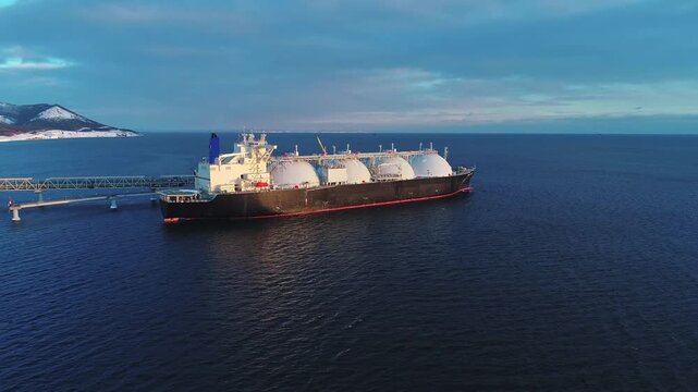 Aerial of Liquified Natural Gas LNG carrier moored to a small gas terminal. Fuel crisis. Sanctions