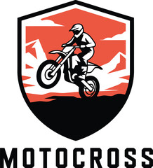 Obraz premium A stylized shield emblem features a motocross rider performing a jump over hills
