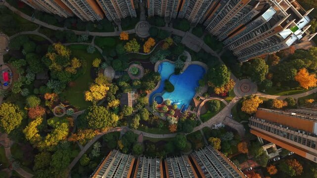 Drone view of residential buildings in China with swimming pool and garden in autumn