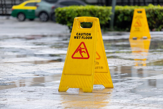 Caution sign in wet pavement