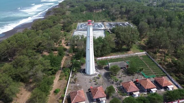 aerial video of lighthouse on the south coast of Java with a blue sea background with big rippling waves