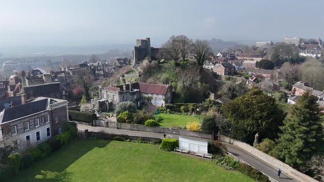 Aerial drone flyover of Lewes Castle, Sussex, England with historic town below. Captures medieval structure, rooftops, streets and surrounding landscape in cinematic high-resolution footage.