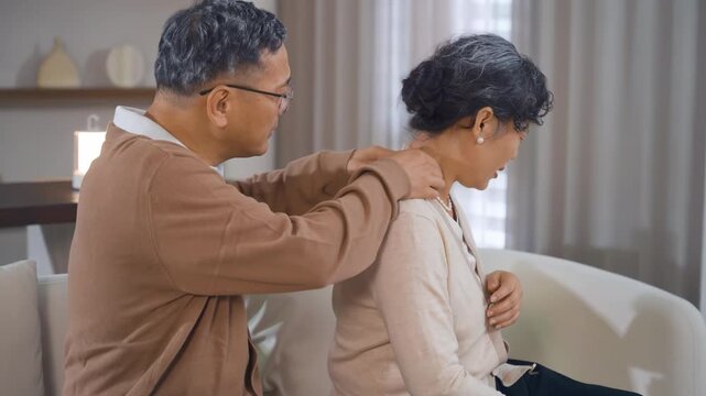 Elderly man help old woman massages neck joints with symptoms of pain in cervical spine spondylosis, osteoarthritis, stenosis, muscle spasms , myofascial pain syndrome, medicine products