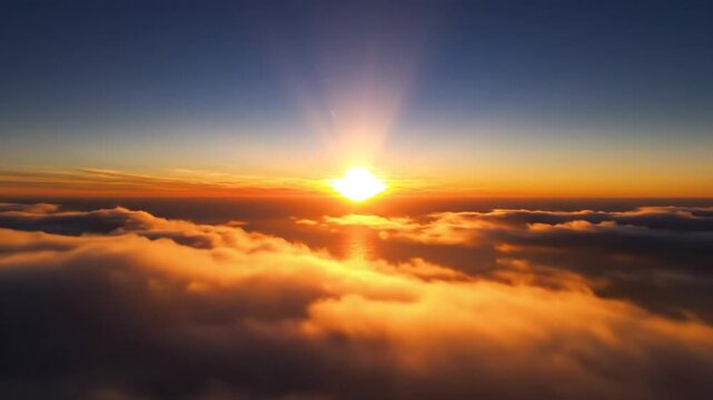 Epic Sunrise Over Clouds Reveals a Radiant Horizon with Sun's Reflection on the Ocean Beneath