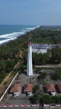 aerial video of lighthouse on the south coast of Java with a blue sea background with big rippling waves