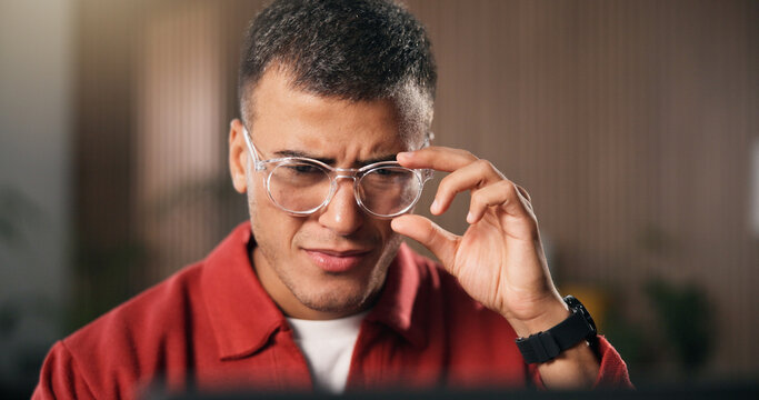 Confusion, glasses and man in office with laptop, draft edit or source feedback for article. Creative, review or journalist in agency with tech, fact check or research error for online publication