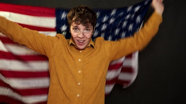 A football fan rejoices at his team's victory and shouts hurray.