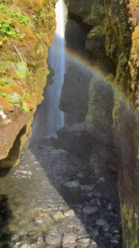 Walking into the canyon towards Gljufrabui waterfall hidden inside the gorge, South Iceland