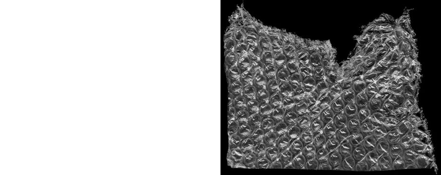 Torn bubble wrap sheet on transparent and black backgrounds.