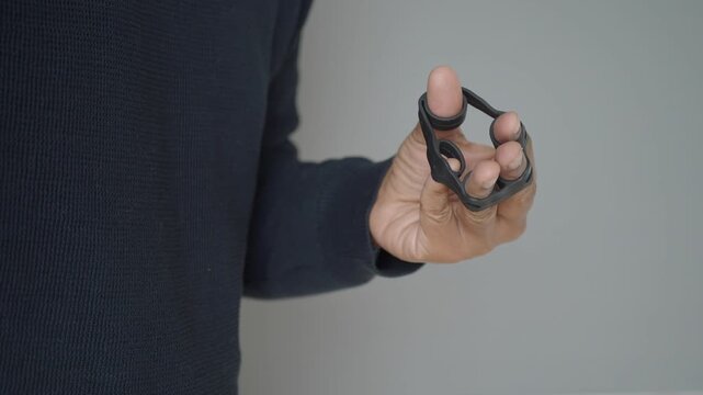 Hand using finger exerciser for strengthening and rehabilitation motion.
