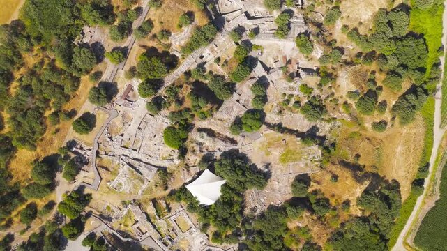 Tevfikiye, Turkey. Aerial view of the Schliemann's Great Trench cutting through multiple layers of Troy, exposing stone walls and earth. Aerial view, HEAD OVER SHOT with rotation