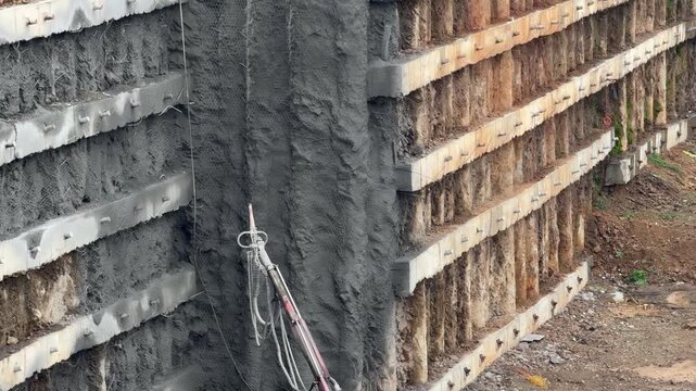 Shotcrete Application and Concrete Mixer Truck at Construction Site