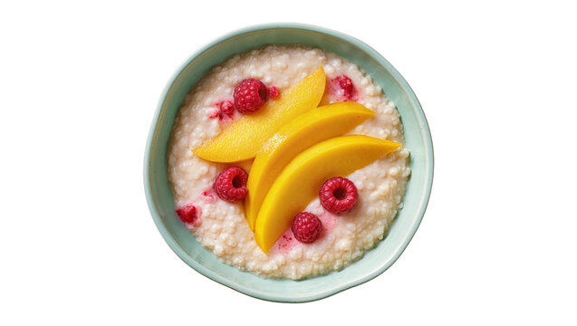 Delicious warm creamy porridge with fresh mango and raspberries in a light blue bowl