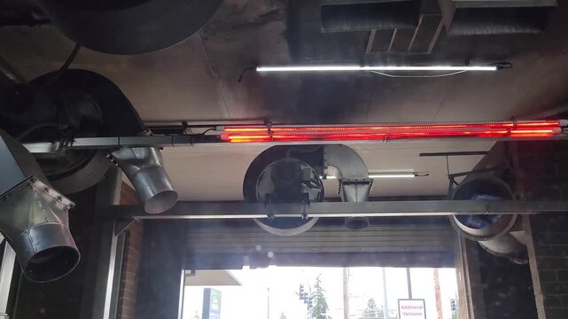 4K driver POV footage inside car of automatic car wash drying process with powerful fans and heaters blowing air during exit stage. Industrial cleaning and airflow concept