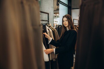 Fototapeta premium Woman buying clothes in a fashion boutique