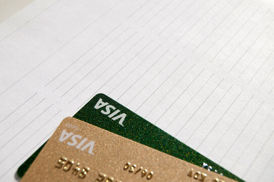 Kyiv, Ukraine - 03 -27 -2026. Visa credit cards on a notebook. Visa payments. Visa cards frame with copy space.