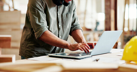 Naklejka na ściany i meble Carpentry, typing or hands with laptop in workshop, creative project or digital planning for craft. Research, furniture inspiration or man with tech for woodworking, check deadline or production info