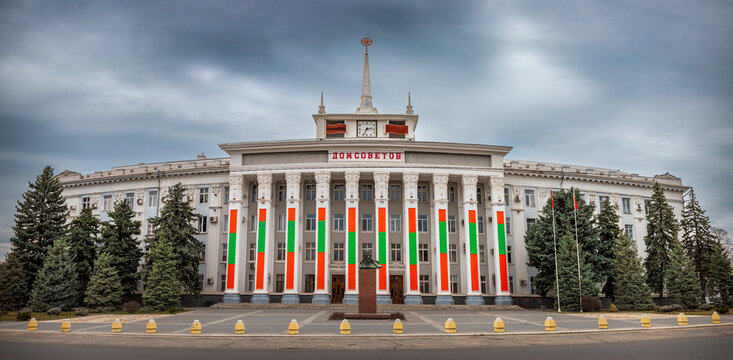 TIRASPOL, TRANSNISTRIA - MARCH 22, 2026: The House of Soviets building, an example of Stalinist Empire architecture serving as City Hall, decorated with the national flag and a bust of Vladimir Lenin.