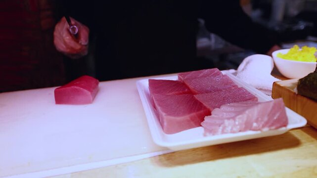 Japanese Chef Slicing Fresh Raw Tuna for Sushi and Sashimi