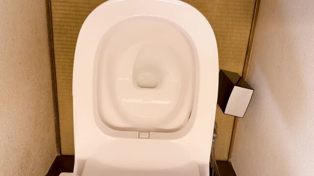 Automatic White Ceramic Toilet Seat Closing in a Japanese Bathroom