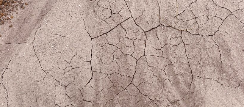Top view of dry cracked soil texture in arid land