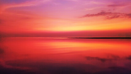 Fototapeta premium Sea beach sunset, ocean sunrise, beautiful tropical island landscape, red orange sky, blurred natural background, golden reflection on calm water, idyllic peaceful atmosphere, summer holiday, vacation