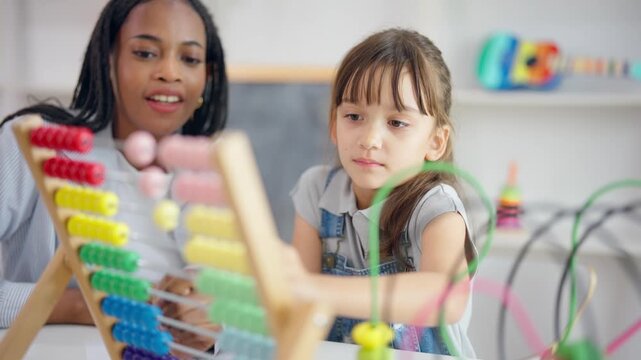 African tutor use educational abacus help a child learn basic math skill.