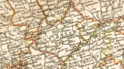 Fototapeta premium Macro View of Vintage Map Highlighting Leicestershire England with Detailed Regional Cartography