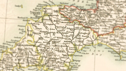 Obraz premium Macro View of Vintage Map Highlighting Devon Shire England with Detailed Regional Cartography
