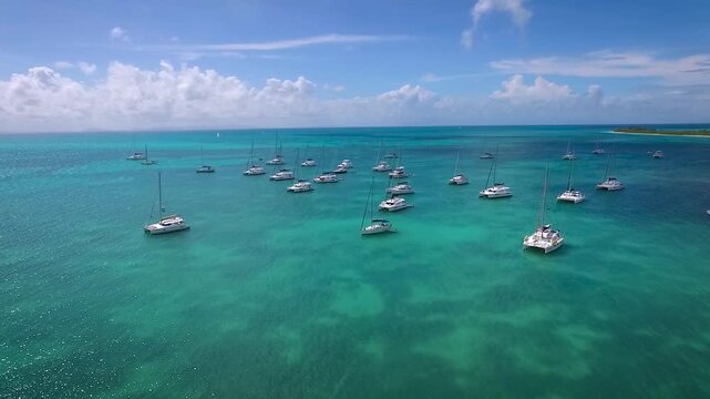 Anegada is an isolated coral reef island in the British Virgin Islands that is surrounded by reefs and picture perfect beaches. Catamarans and other boats anchor and moor in Setting Point Bay.