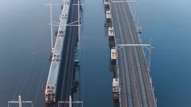Train Crossing Old Raritan River Drawbridge with New Bridge Under Construction in Perth Amboy New Jersey USA Aerial View