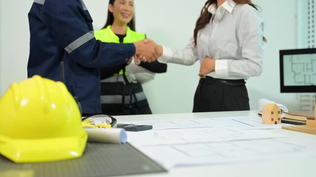 Engineer teams meeting working together wear worker helmets hardhat on construction site in modern city.