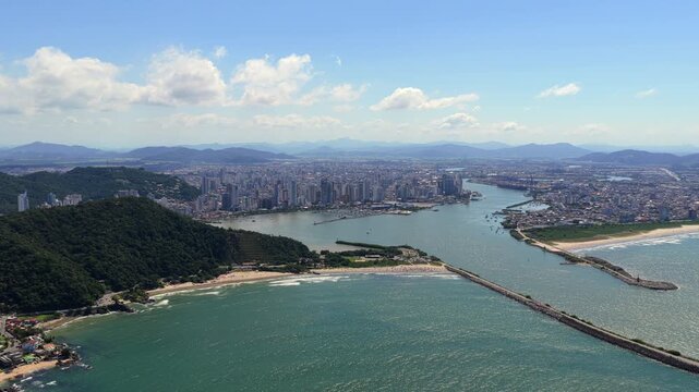 Itajai and Navegantes at the Itajai Acu River mouth in Santa Catarina, South Brazil, with harbor breakwaters, Morro do Atalaia in the foreground and Serra do Itajai in the background, aerial view