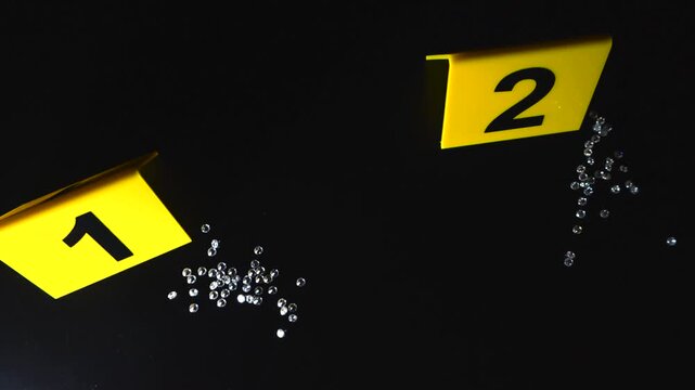 Yellow forensic markers numbering evidence at a crime scene where multiple precious diamonds are found scattered on a dark surface, representing a jewel heist or robbery investigation