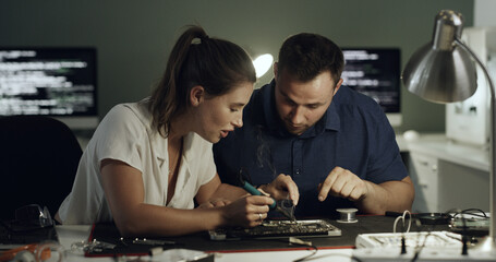 Fototapeta premium Soldering, test or team in office with circuit board, repair or wiring guidance in hardware check. Electronics, people or engineers with tech, maintenance support or collaboration in system fix.
