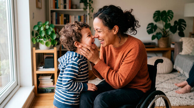 Mother in wheelchair shares a tender, joyful moment with her young son at home