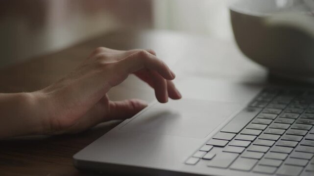 Hand Browsing on Laptop Touchpad Close Up