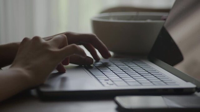Hands Coding on Laptop at Desk