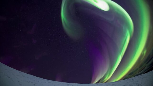 Emerald aurora swirling night sky, dancing green and purple ribbons curl into massive vortex above snow rim, panoramic polar vista with starfield backdrop, dramatic motion and ethereal illumination,
