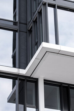 Sharp angle view of a modern glass office building window on an architectural facade showing geometry and minimalism in clean daylight
