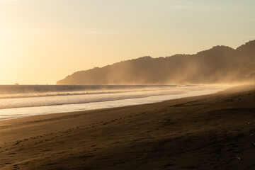 The low sun's golden light illuminates the ocean spray on Carate Beach, with views of Corcovado NP at sunset. Costa Rica. © jiriviehmann