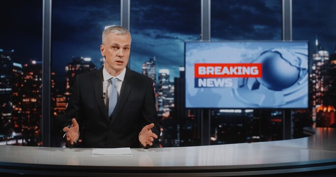 Confident Male Reporter in Formal Wear Presenting Story, Holding Pen and Looking at Camera. Broadcast Journalism Featuring Breaking News Digital Monitor and City Skyscrapers. Digital Media Journalism.