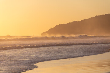 The low sun's golden light illuminates the ocean on Carate Beach, with views of Corcovado NP at sunset. Costa Rica. © jiriviehmann