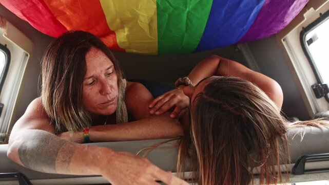 Lesbian couple having an intimate conversation in a camper van