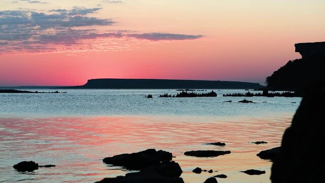 Sunrise over Baltic Sea with cormorant silhouettes and Lilla Karls&ouml; island on horizon, Stora Karls&ouml; Gotland Sweden